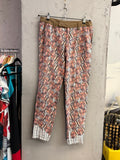 BERLIN VINTAGE CORNER Custo Barcelona trousers featuring a rust, cream, and charcoal leaf print with an olive waistband.