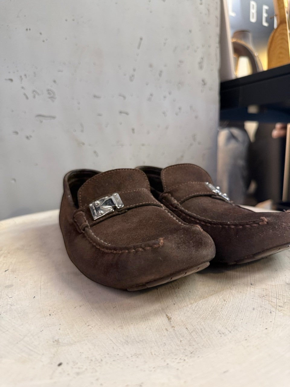 BERLIN VINTAGE CORNER dark brown suede driving loafers with metal detail and moc-toe construction.