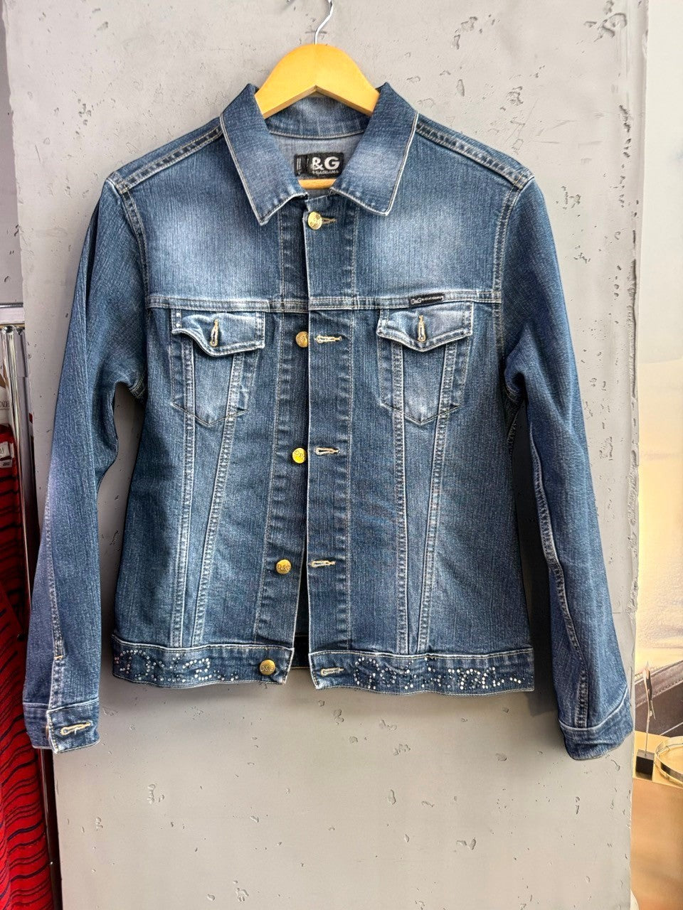 BERLIN VINTAGE CORNER D&G Dolce & Gabbana medium wash denim jacket with crystal hem embellishments and metallic buttons.