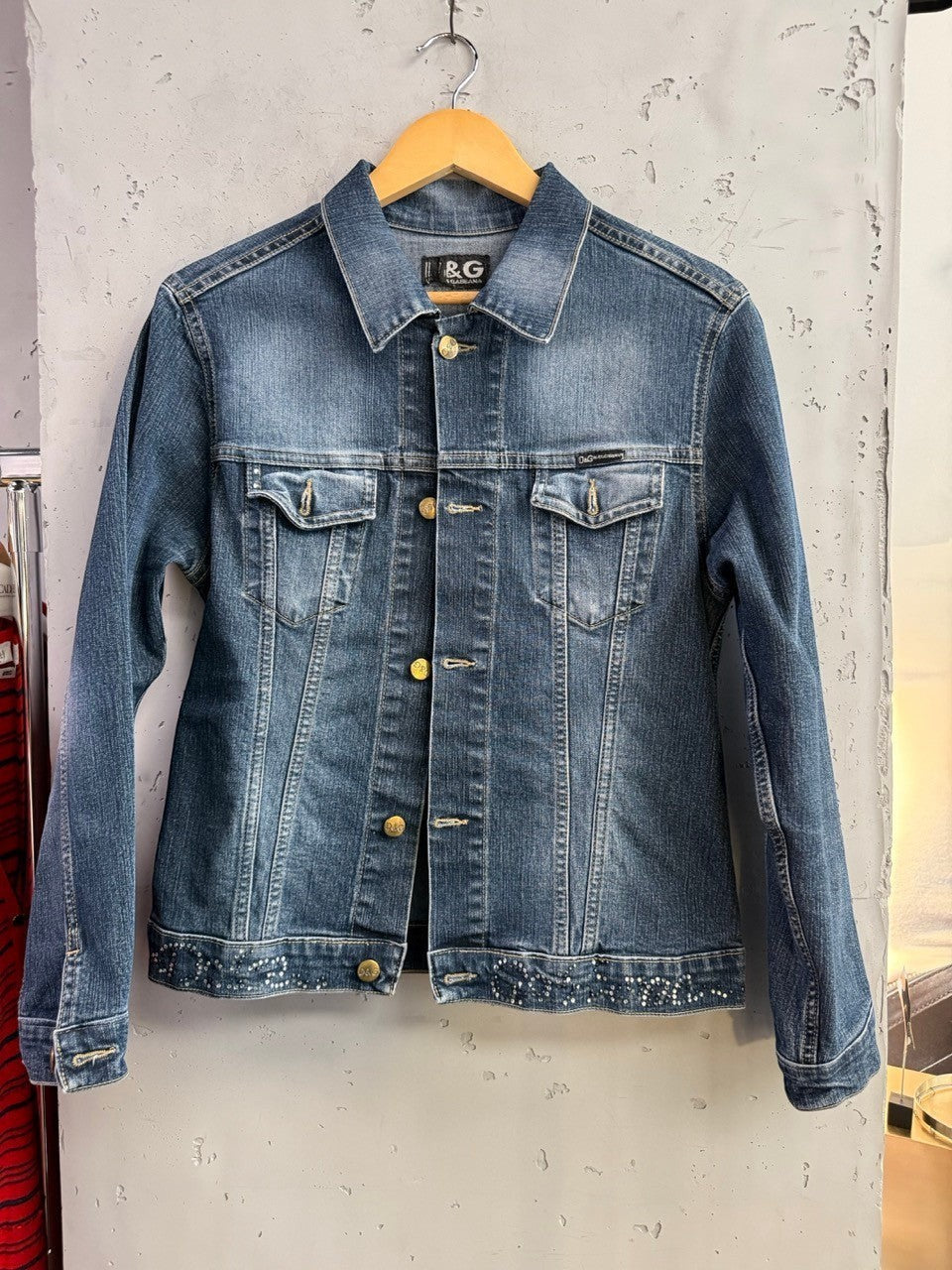 BERLIN VINTAGE CORNER D&G Dolce & Gabbana medium wash denim jacket with crystal hem embellishments and metallic buttons.