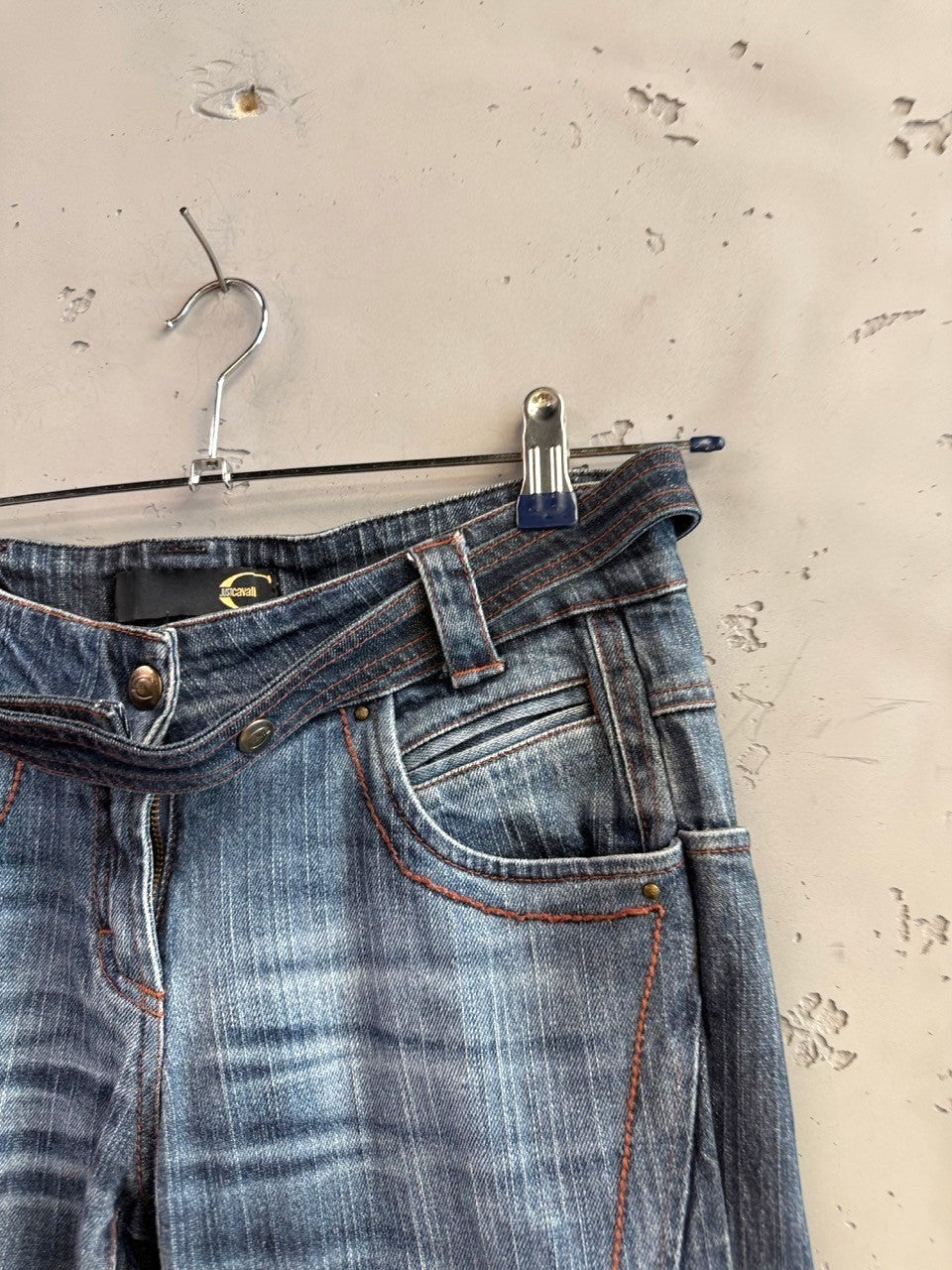 BERLIN VINTAGE CORNER mid-wash distressed denim jeans with integrated belt and orange stitching.
