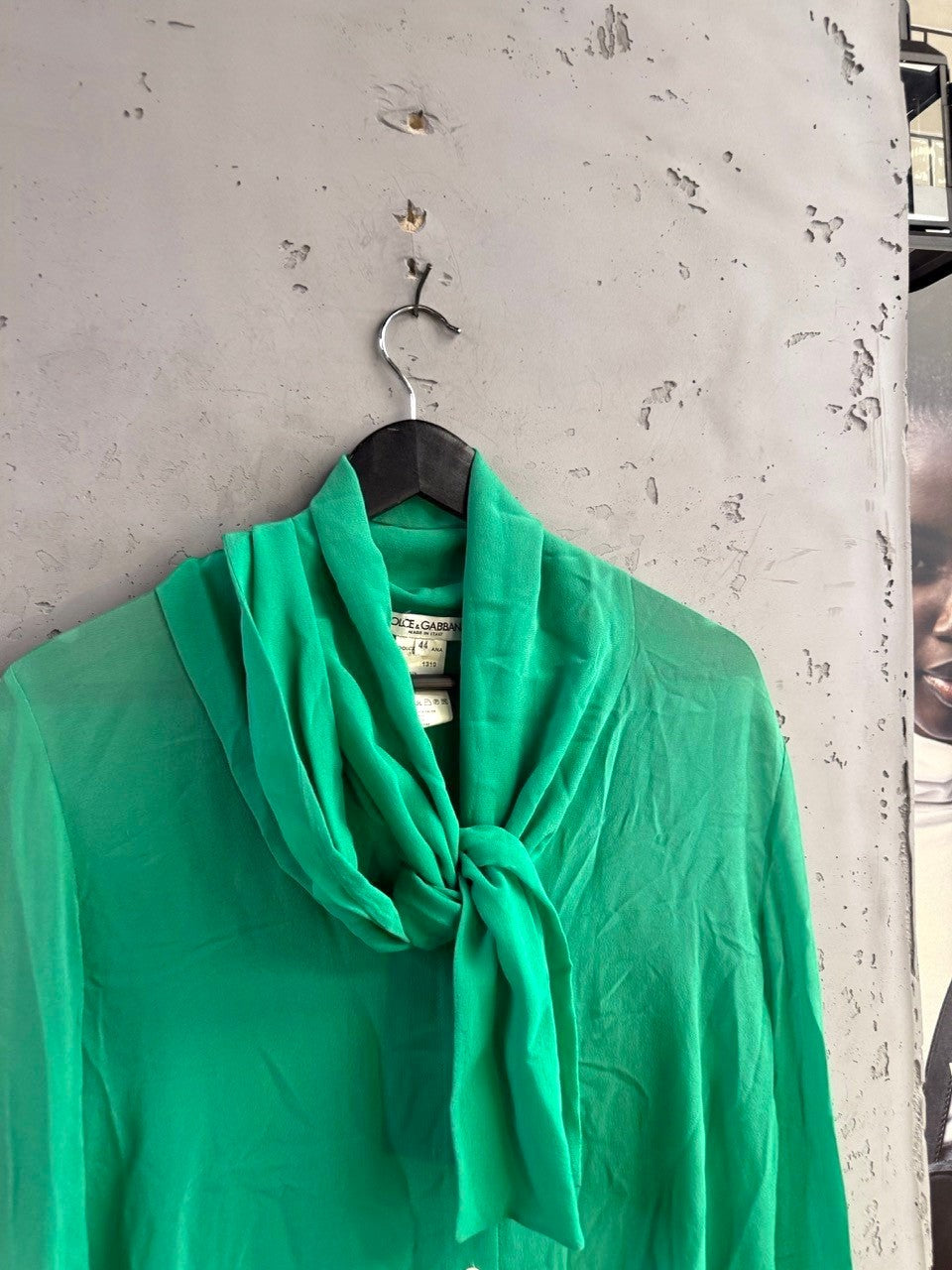 BERLIN VINTAGE CORNER emerald green Dolce & Gabbana silk pussy bow blouse with long sleeves on a hanger.