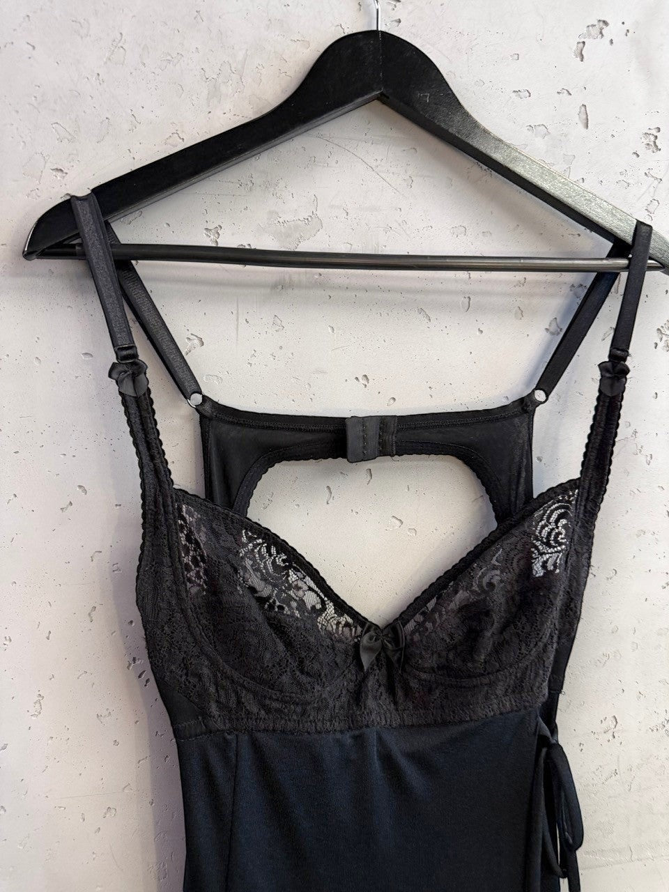 BERLIN VINTAGE CORNER D&G Dolce & Gabbana black mini dress with lace bodice and cut-out back detail on a hanger.