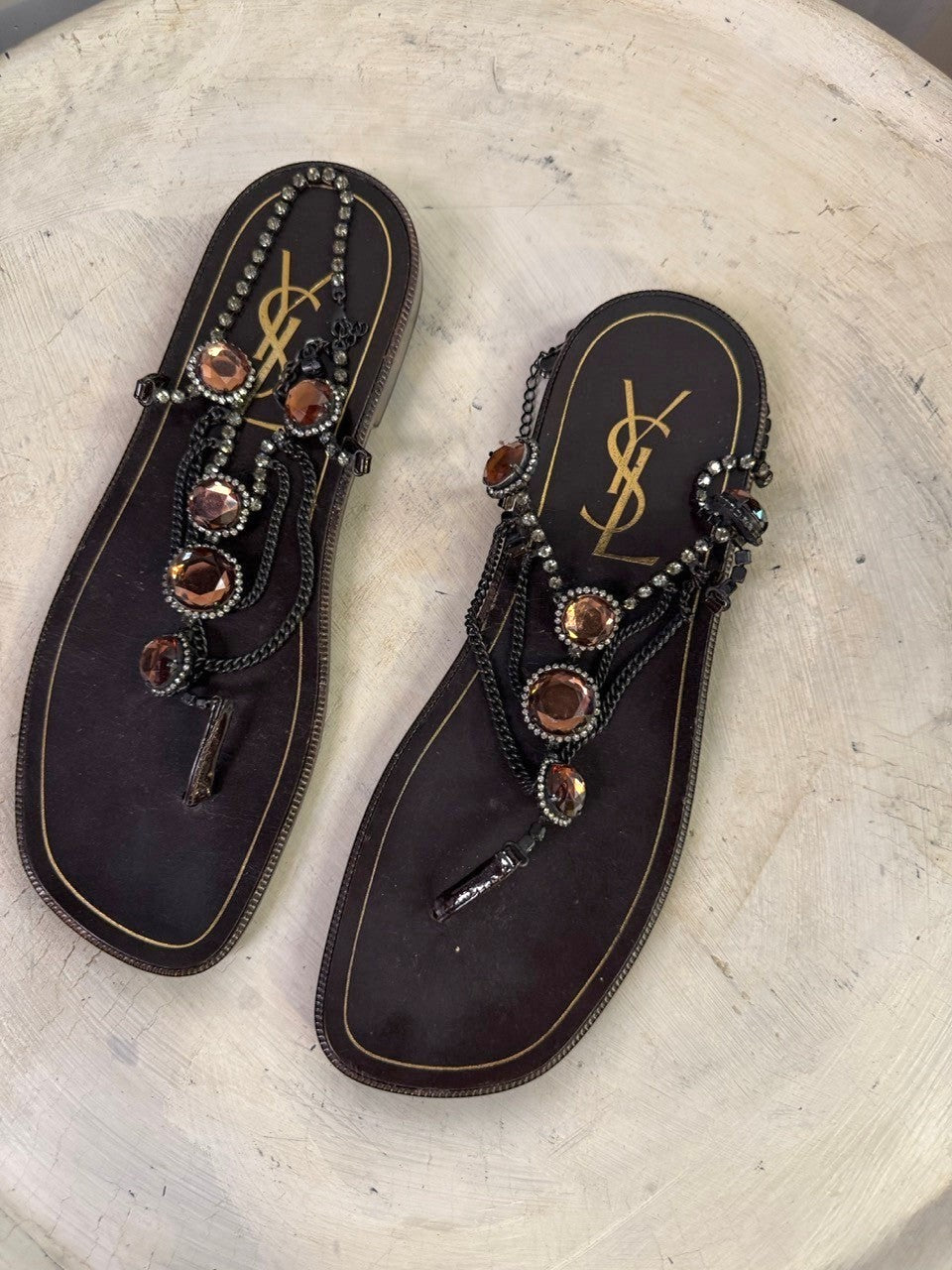 BERLIN VINTAGE CORNER dark brown leather thong sandals with rhinestone and amber embellishments and YSL logo.