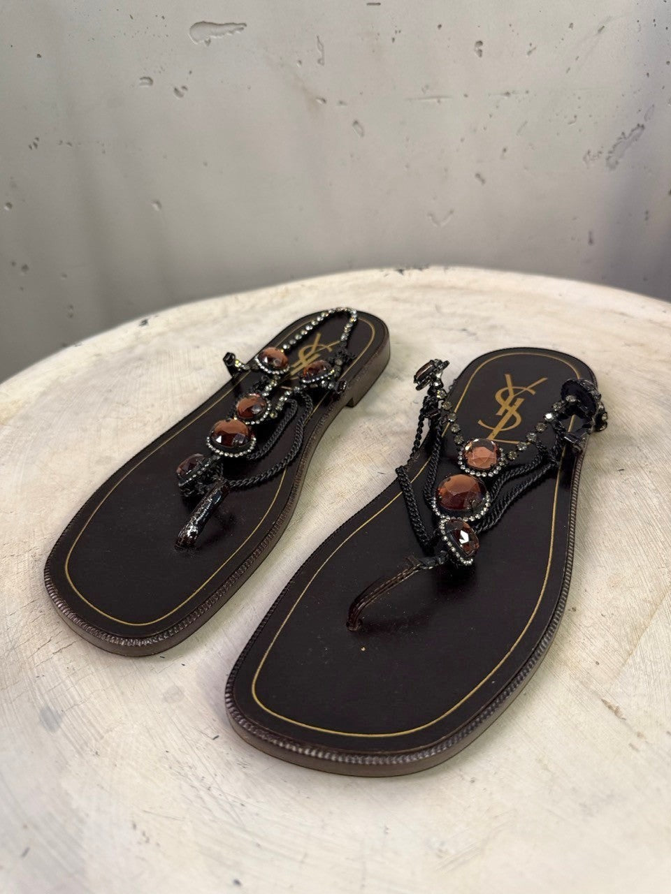 BERLIN VINTAGE CORNER dark brown leather thong sandals with rhinestone and amber embellishments and YSL logo.