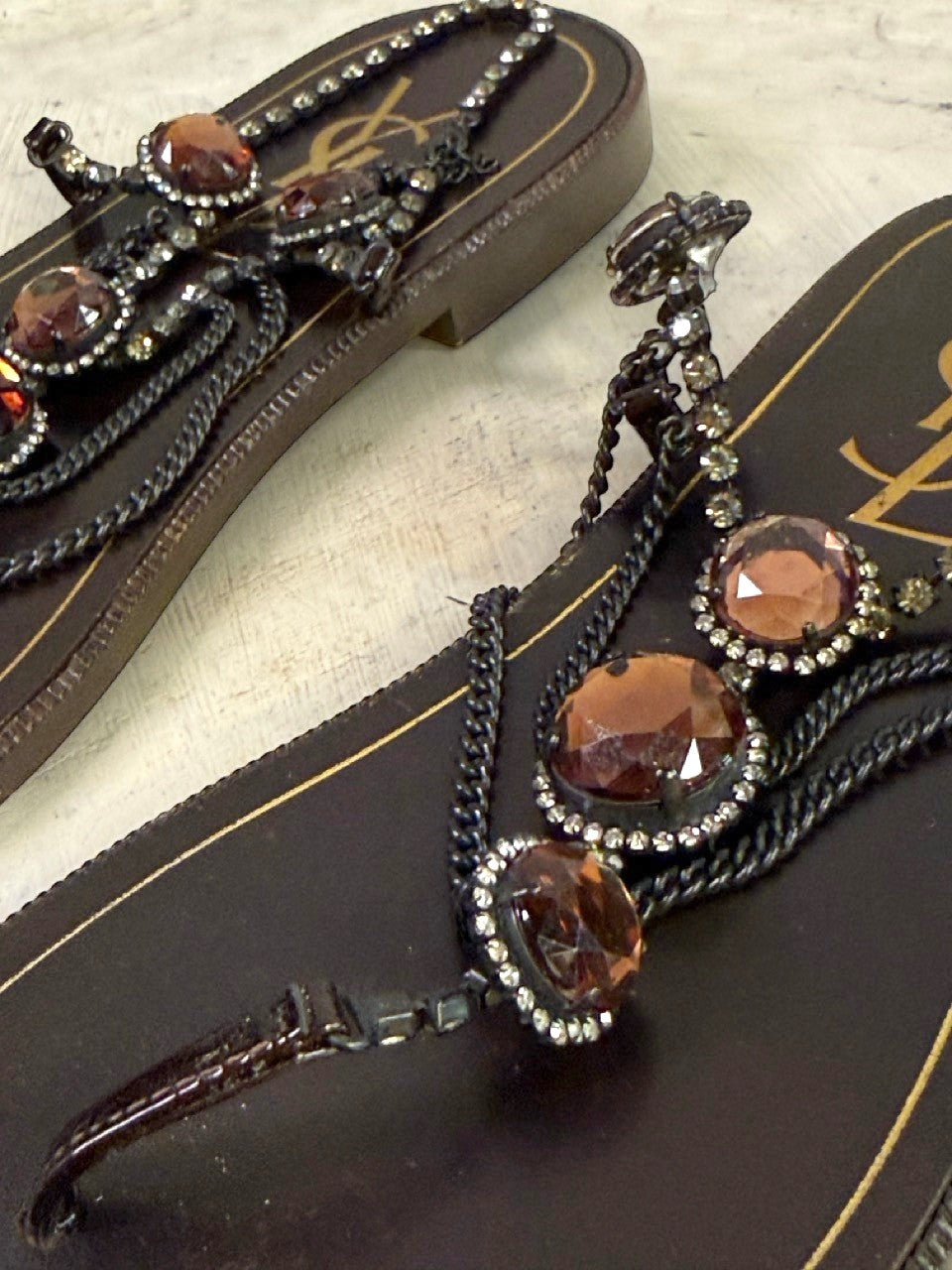BERLIN VINTAGE CORNER dark brown leather thong sandals with rhinestones, amber stones, and chain embellishments.