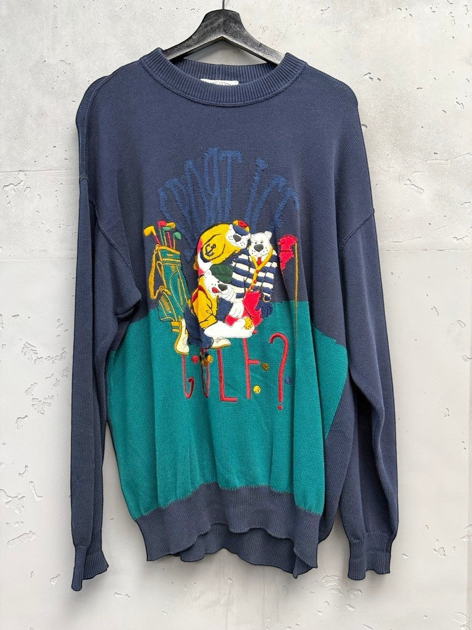 BERLIN VINTAGE CORNER navy and teal knit sweater with embroidered cartoon bears playing golf. Features a retro, whimsical design.