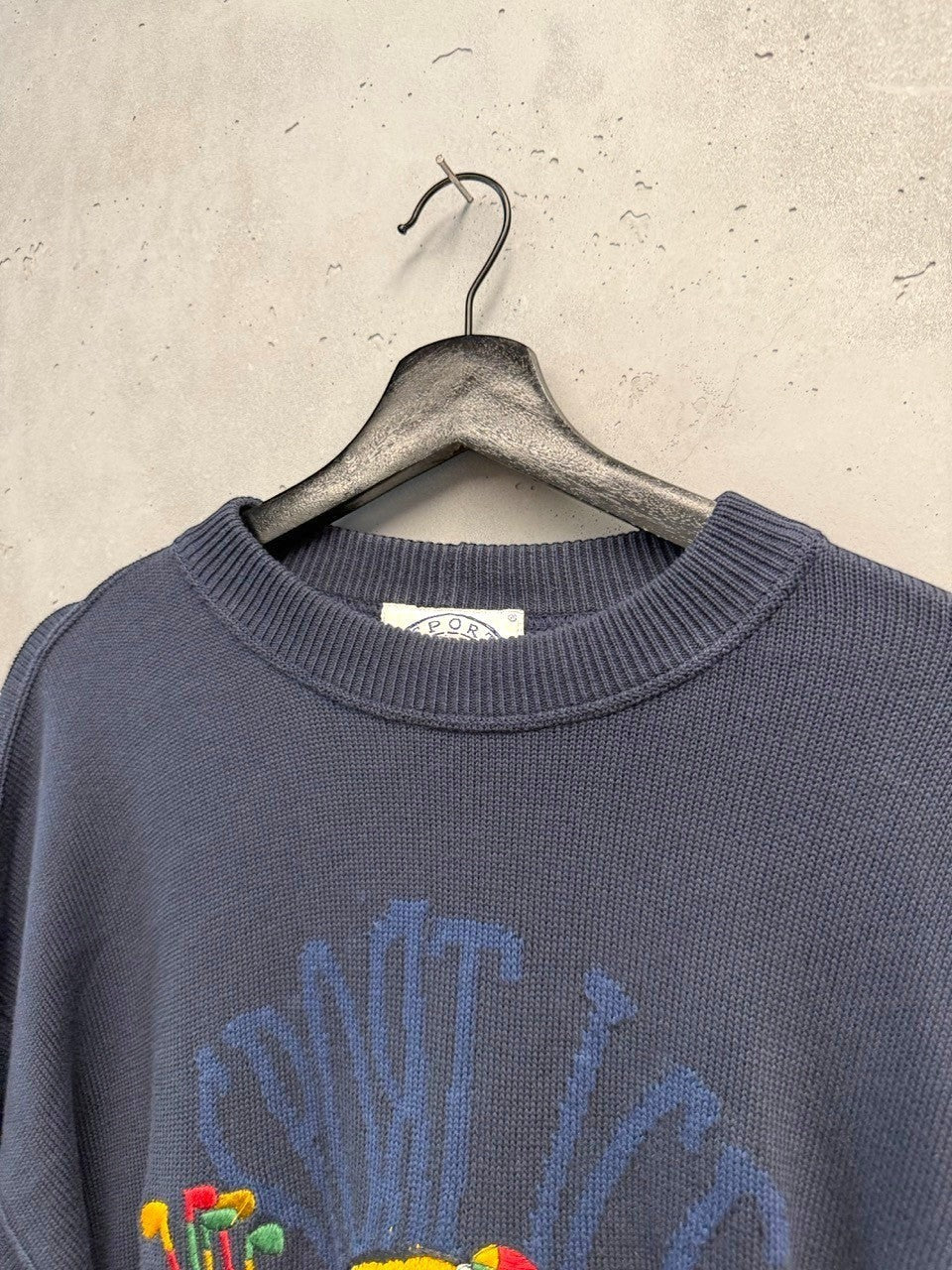 BERLIN VINTAGE CORNER navy knit sweater with embroidered cartoon golf bears and teal accents. Crew neck, long sleeves.