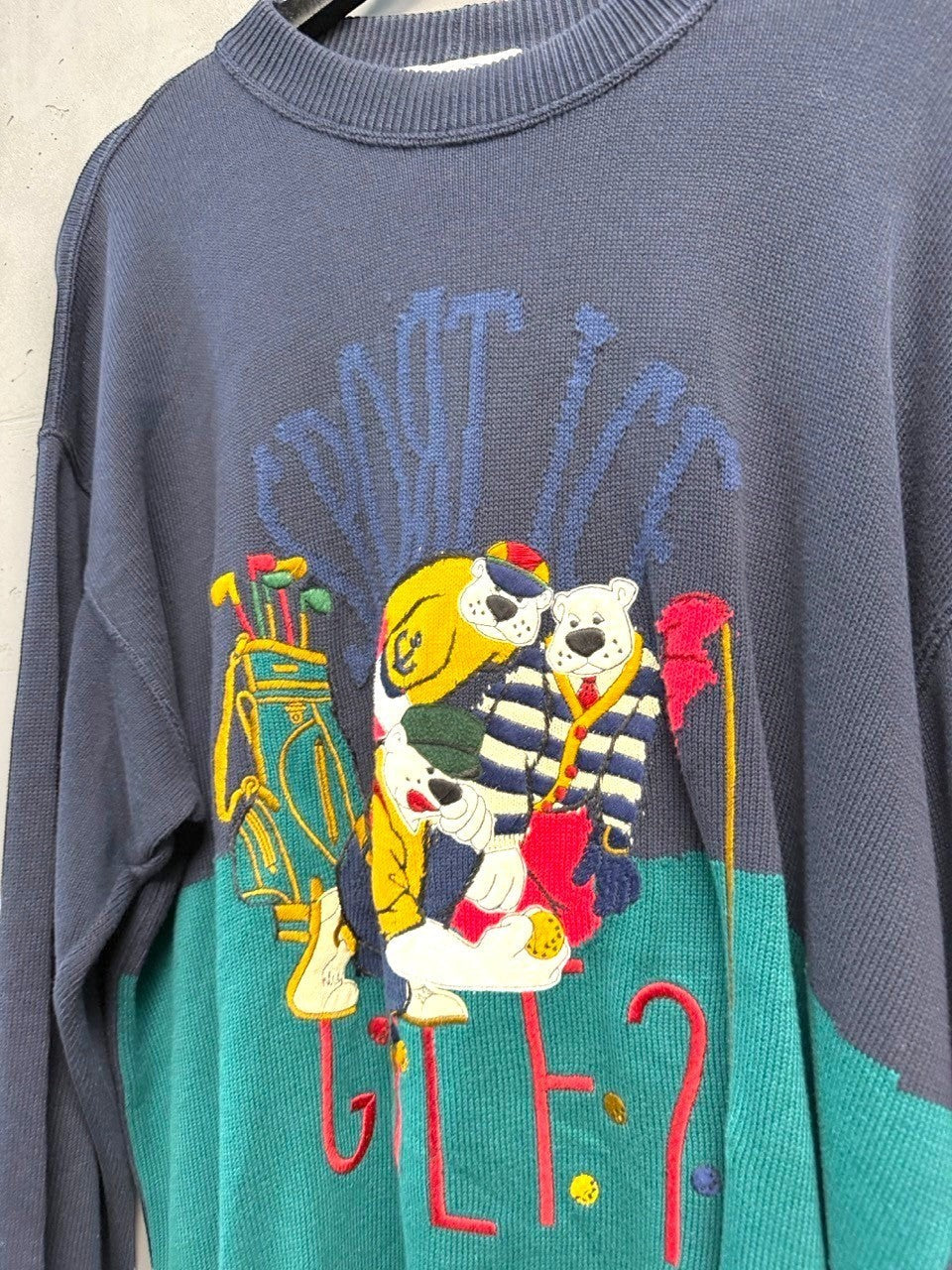 BERLIN VINTAGE CORNER navy and teal knit sweater with embroidered cartoon bears playing golf. Features "DON'T LIKE GOLF?" text.