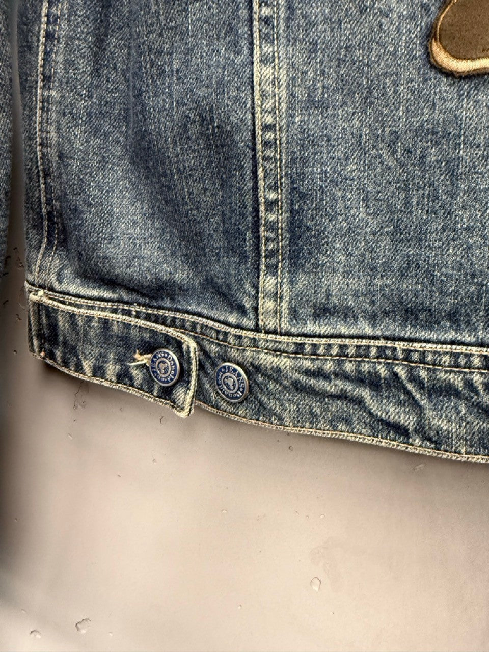 BERLIN VINTAGE CORNER blue washed denim jacket with embroidered Mickey Mouse motif and button details.