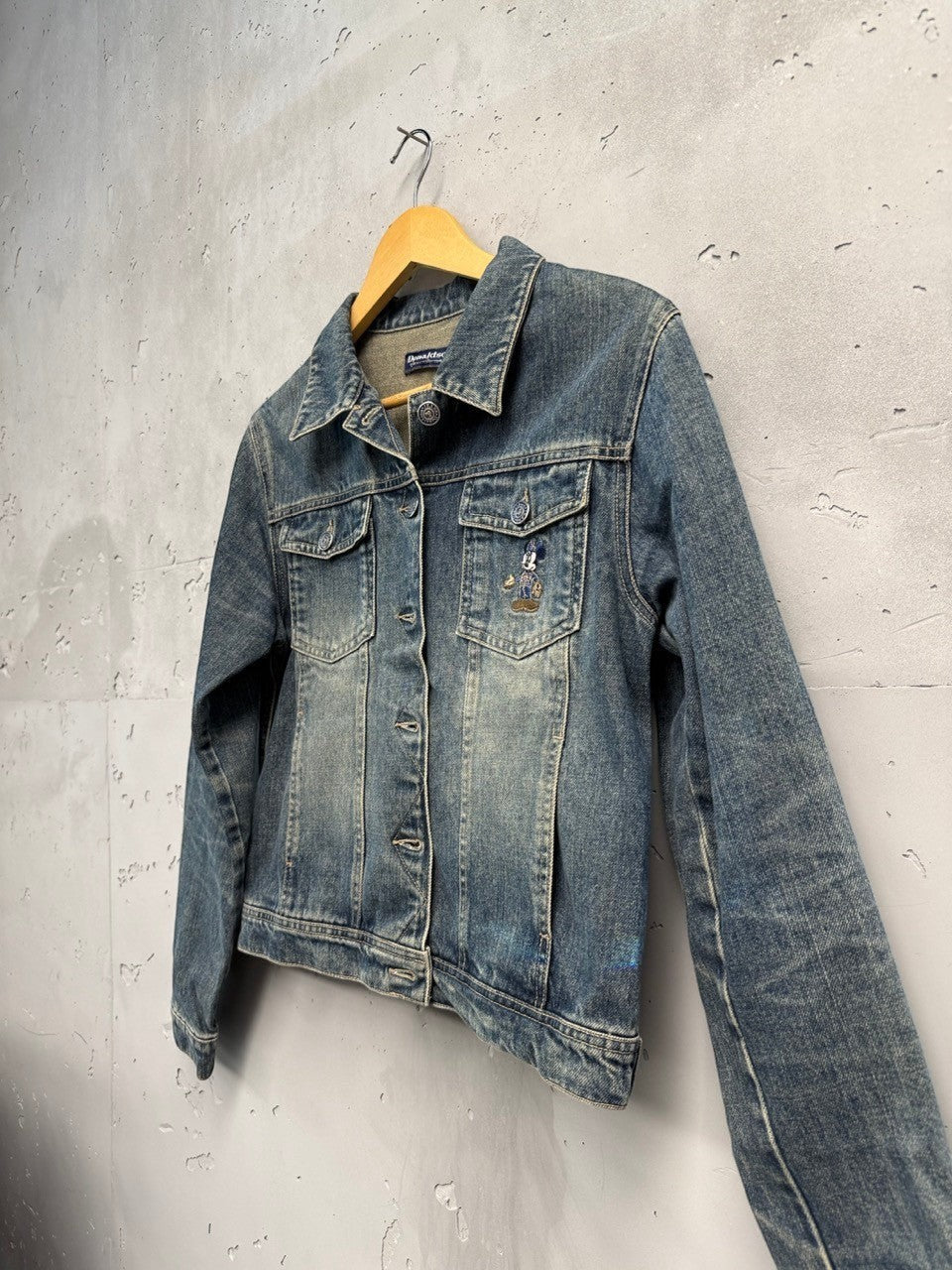 BERLIN VINTAGE CORNER blue washed denim jacket with embroidered Mickey Mouse motif, button-down front, chest pockets, and classic trucker silhouette.