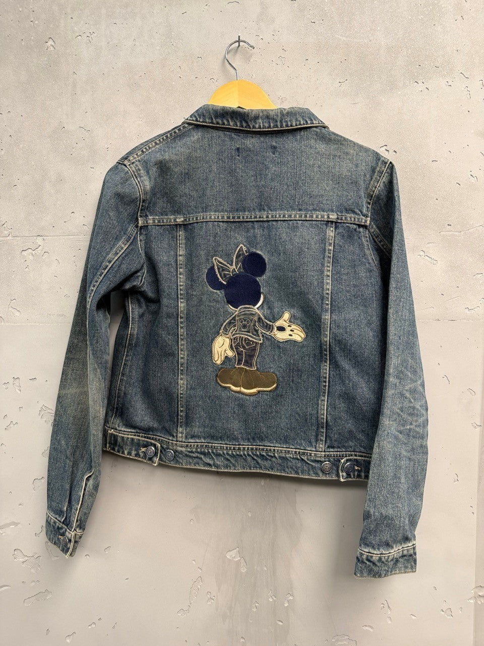 BERLIN VINTAGE CORNER blue denim jacket with embroidered Minnie Mouse on back. Classic trucker style with button front.