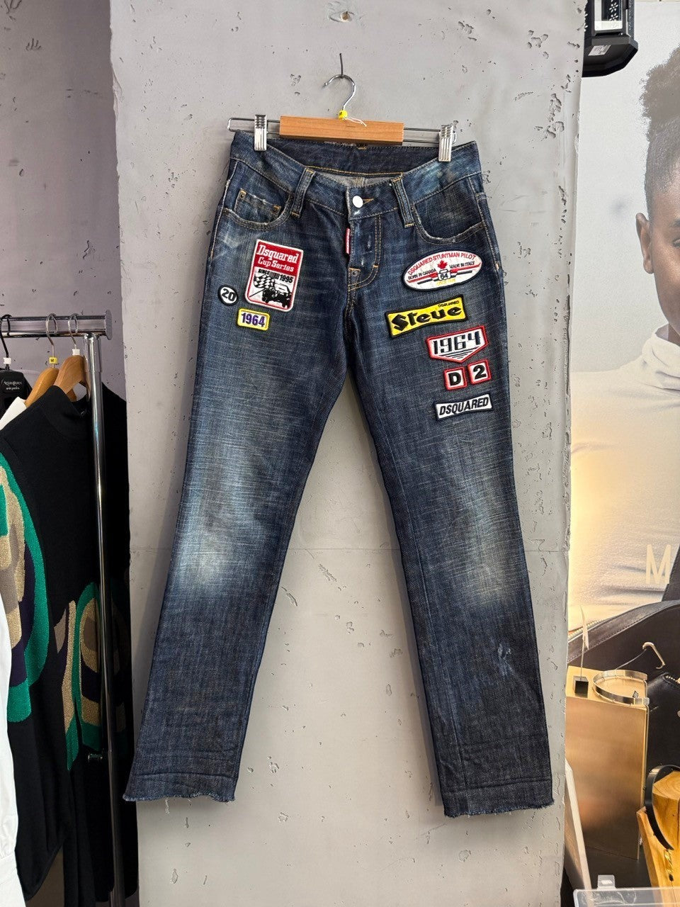 BERLIN VINTAGE CORNER blue denim jeans with distressed finish and retro patches including "Dsquared Cup Series Since 1995" and "Steer"