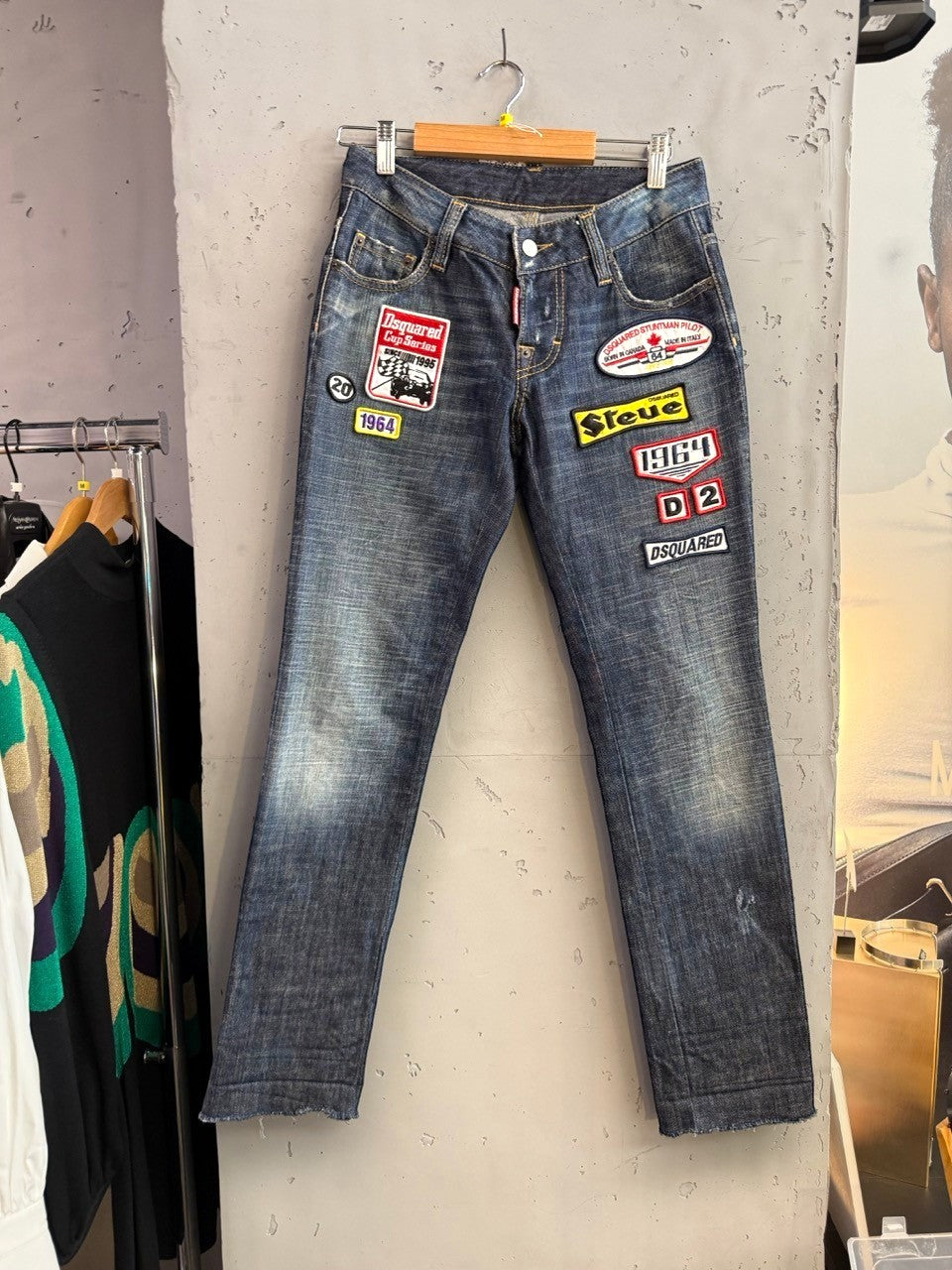 BERLIN VINTAGE CORNER blue denim jeans with distressed finish and embroidered patches including "Dsquared Cup Series" and "Steer".
