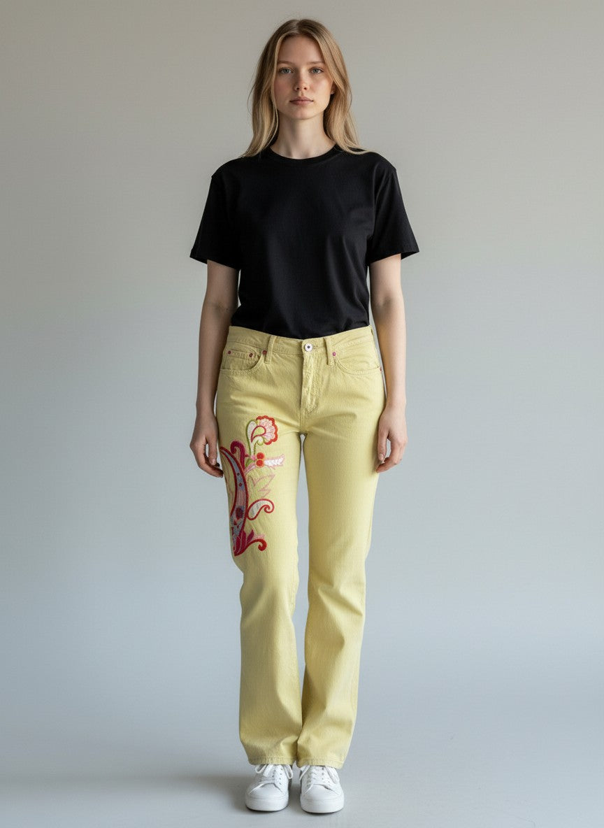 BERLIN VINTAGE CORNER light yellow denim flare jeans with embroidered paisley design on left leg in pink, red, and blue.