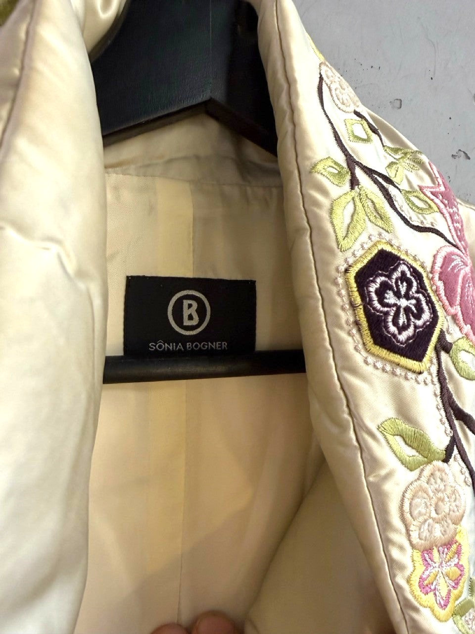 BERLIN VINTAGE CORNER champagne satin puffer vest with intricate multi-colored floral embroidery and high collar.