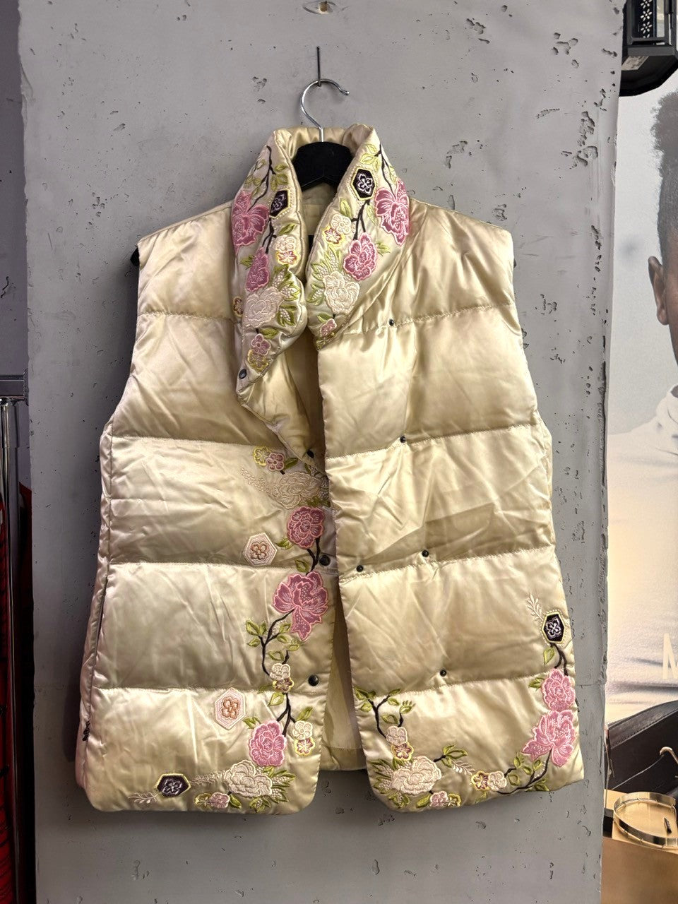 BERLIN VINTAGE CORNER champagne satin puffer vest with intricate floral embroidery and snap-button closure.