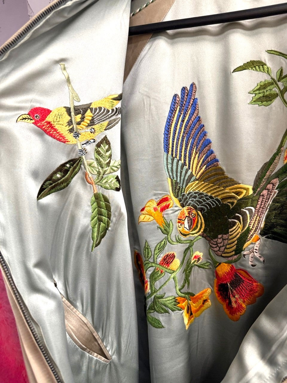 BERLIN VINTAGE CORNER champagne satin bomber jacket with embroidered birds and flowers. Features ribbed cuffs and hem.