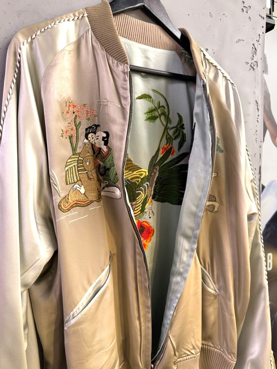 BERLIN VINTAGE CORNER champagne satin bomber jacket with traditional Japanese embroidery of figures and cherry blossoms.