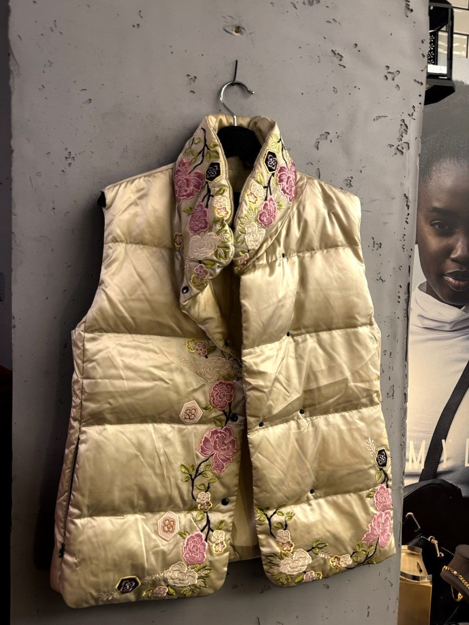 BERLIN VINTAGE CORNER champagne satin puffer vest with intricate multi-colored floral embroidery and snap buttons.