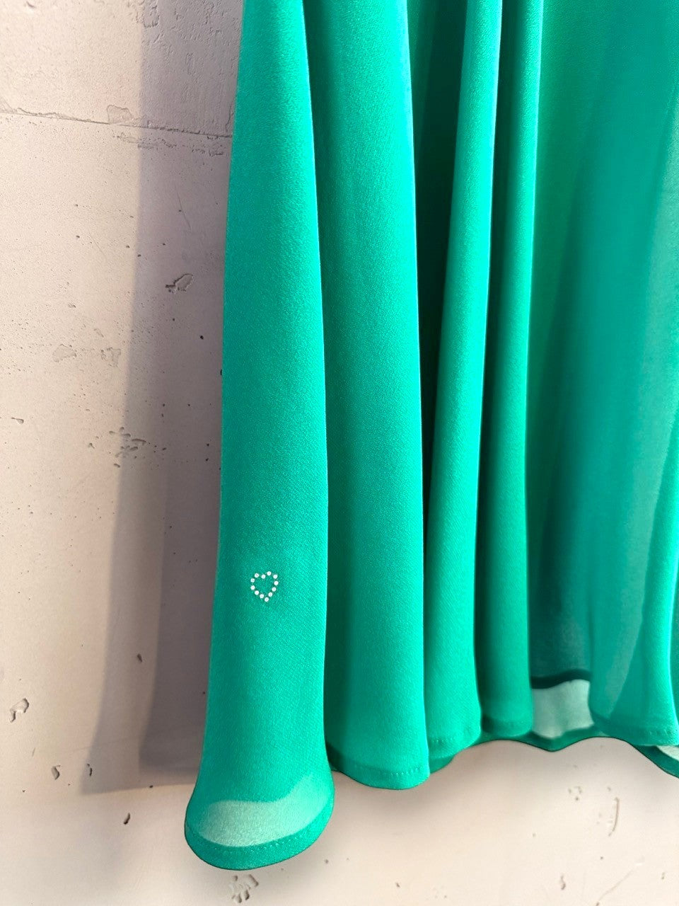 BERLIN VINTAGE CORNER emerald green sheer camisole dress featuring a delicate rhinestone heart detail at the hem.
