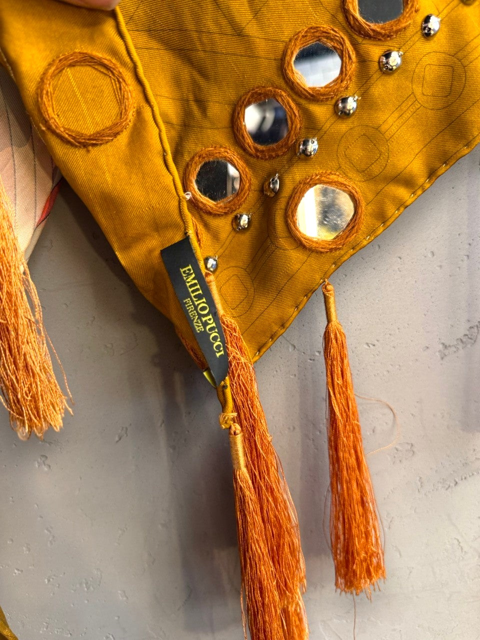 BERLIN VINTAGE CORNER Emilio Pucci mustard scarf with circular embroidery, reflective mirror accents, and long tassels.