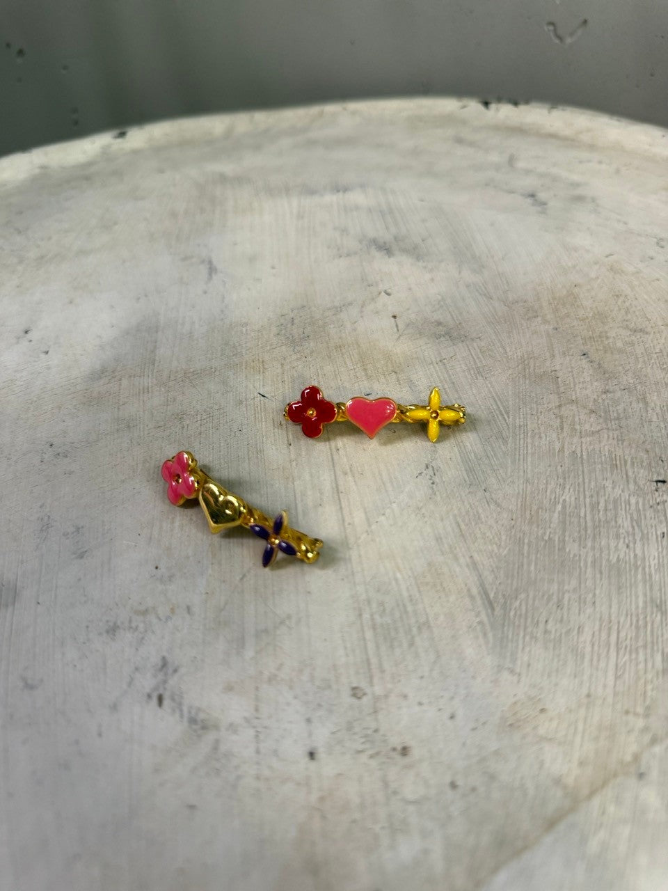 BERLIN VINTAGE CORNER gold-tone enamel hair clips with red, pink, yellow, and purple charms in flower and heart shapes.