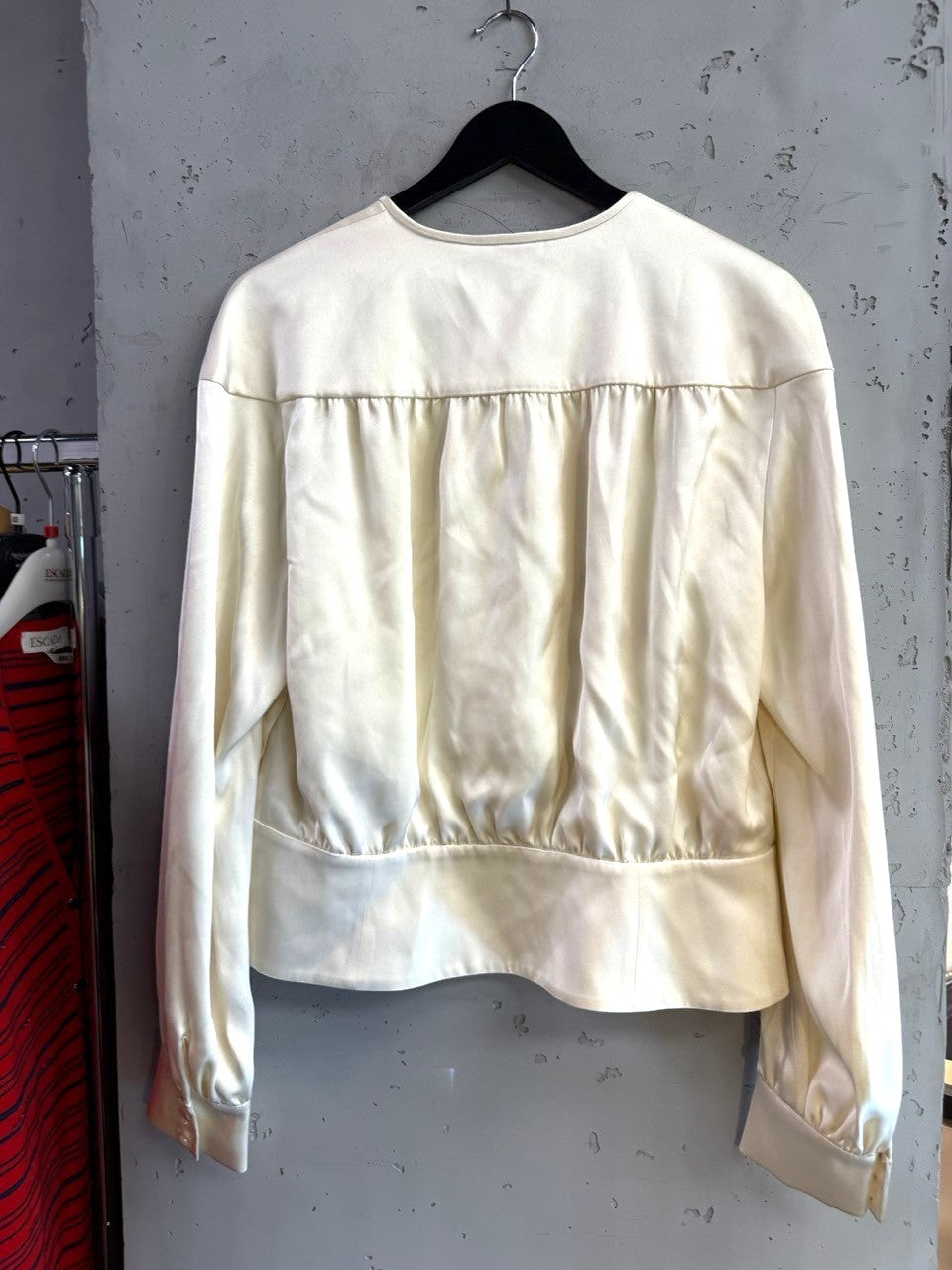 BERLIN VINTAGE CORNER cream Escada silk blouse with gathered back detailing and long sleeves on a hanger.