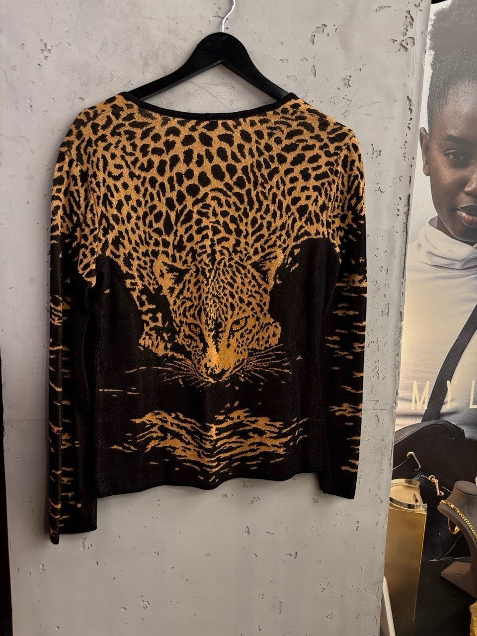 BERLIN VINTAGE CORNER ESCADA knit cardigan featuring a black and gold leopard print design on a hanger.
