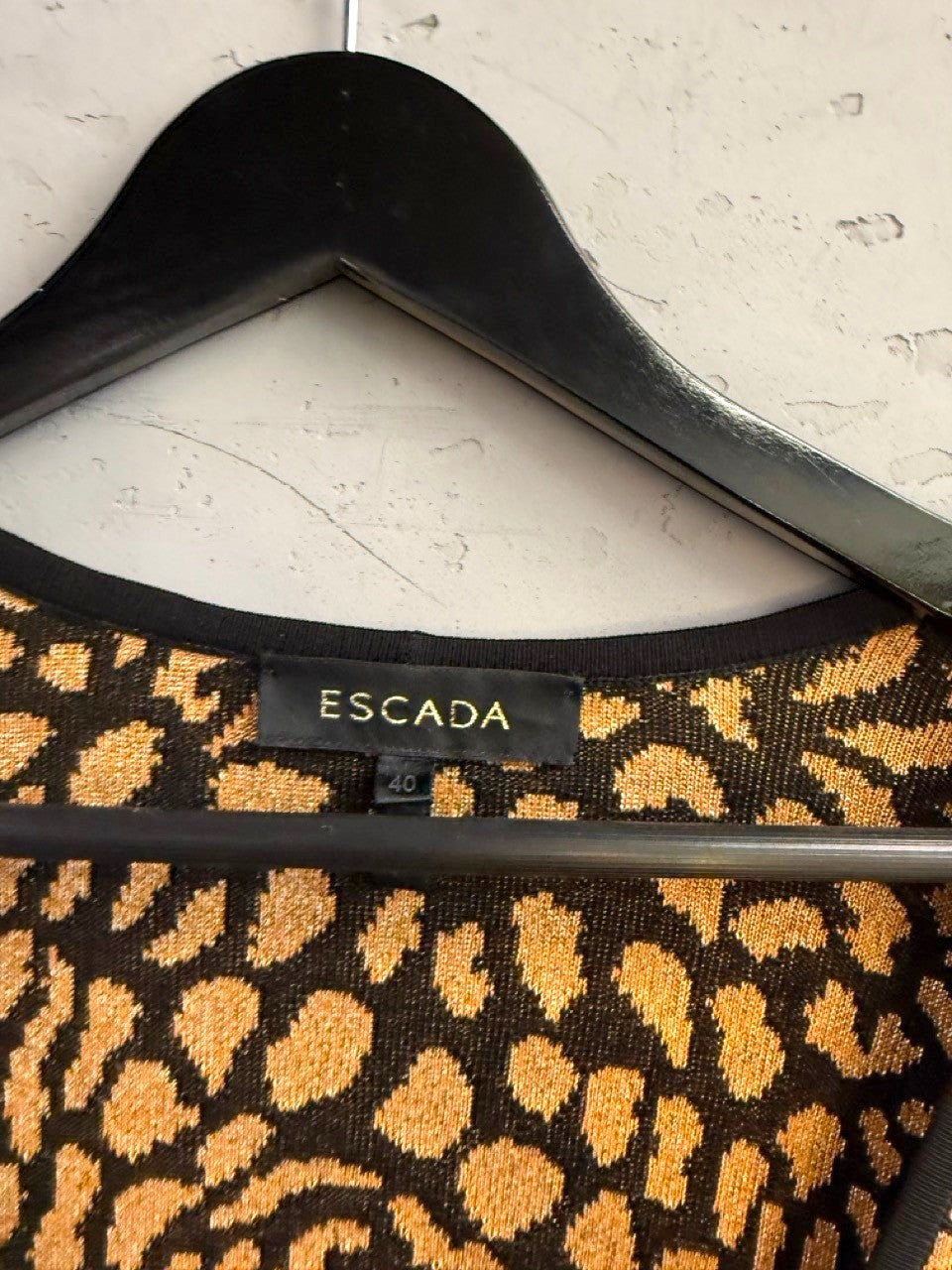 BERLIN VINTAGE CORNER Escada knit cardigan featuring a black and gold leopard print pattern on a hanger.