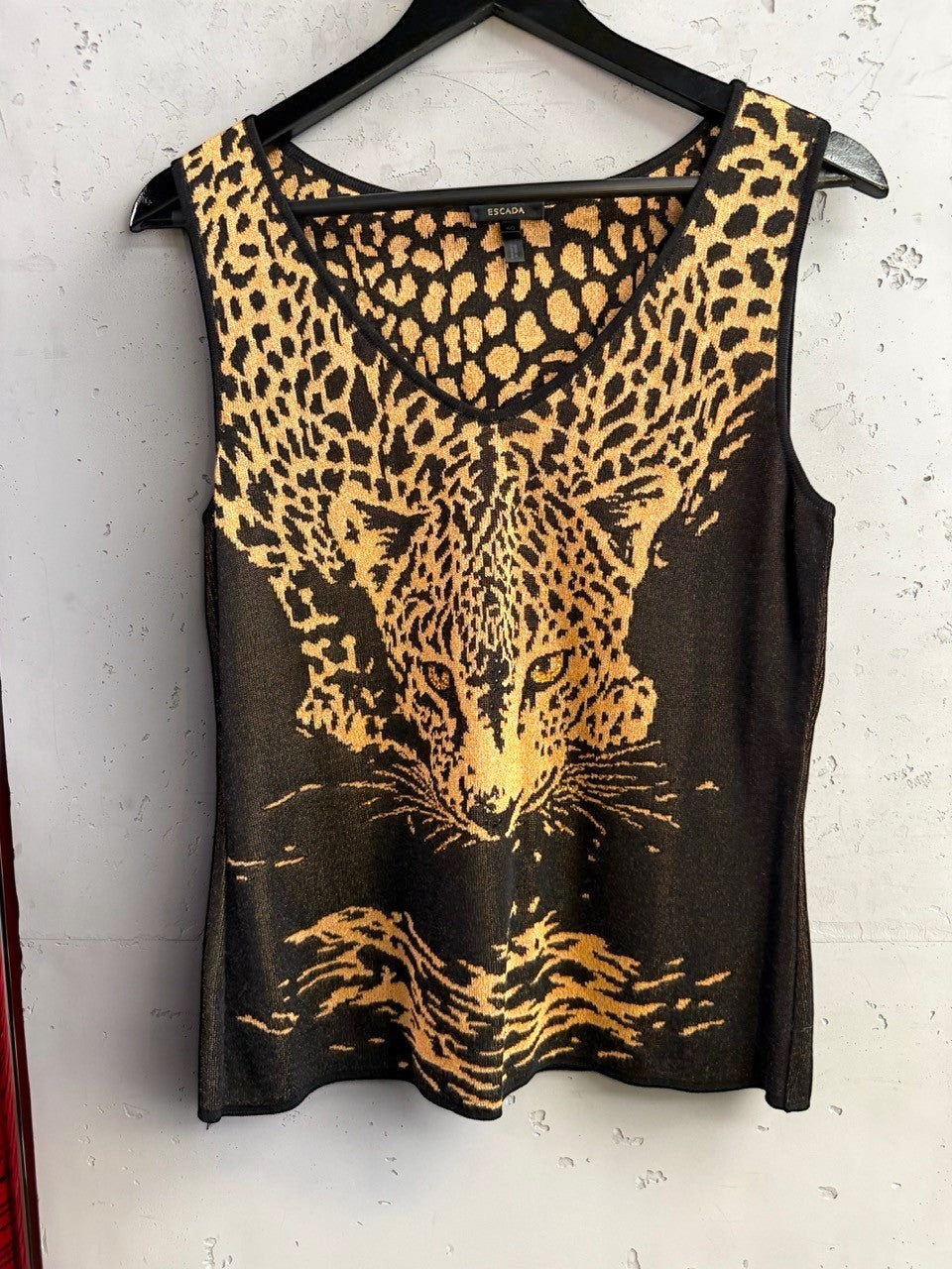 BERLIN VINTAGE CORNER Escada sleeveless knit top with a black and gold leopard print and V-neckline.