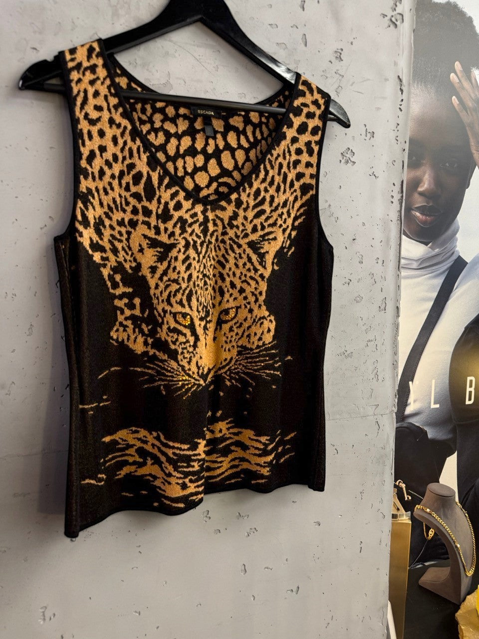 BERLIN VINTAGE CORNER Escada sleeveless knit top featuring a black and gold leopard print design with a V-neckline.