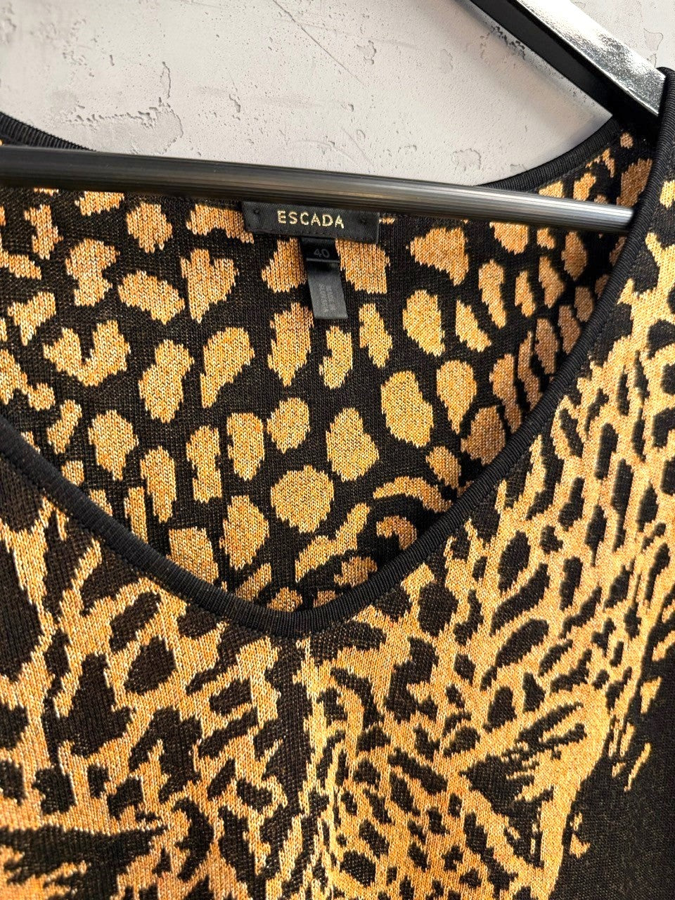 BERLIN VINTAGE CORNER Escada sleeveless knit top featuring a black and gold leopard print and a V-neckline.