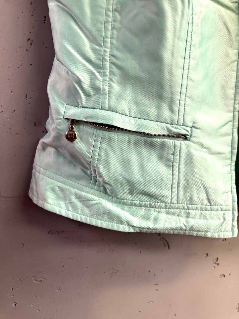 BERLIN VINTAGE CORNER Escada mint green sleeveless zip-up vest with zippered side pockets and structured paneling.