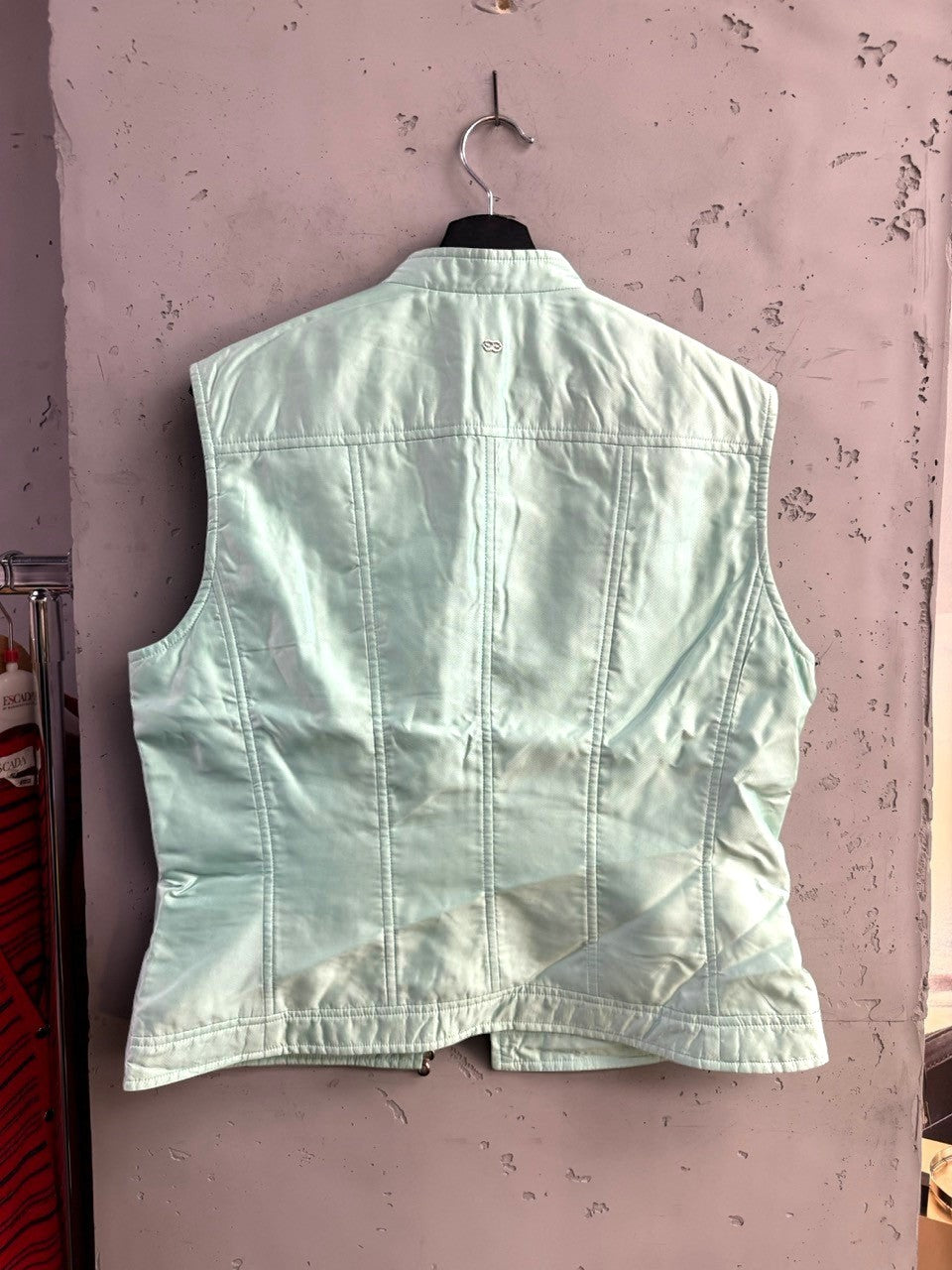 Back view of a mint green Escada sleeveless zip-up vest with paneling and a stand-up collar from BERLIN VINTAGE CORNER