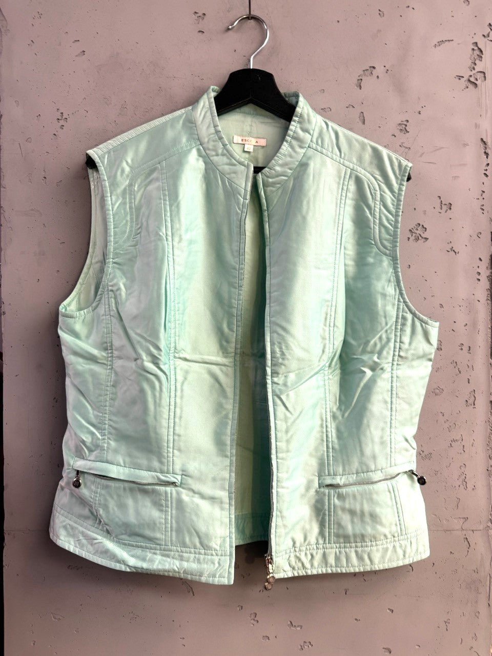 BERLIN VINTAGE CORNER Escada mint green sleeveless zip-up vest with stand-up collar and zippered side pockets.