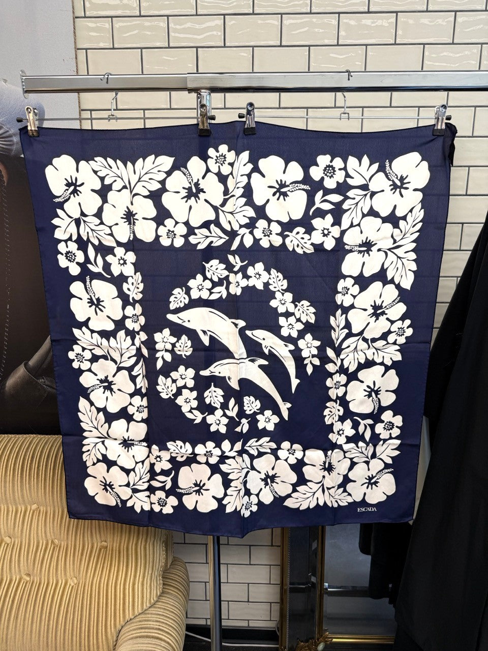 BERLIN VINTAGE CORNER Escada vintage navy blue silk scarf featuring a white floral and dolphin print pattern.