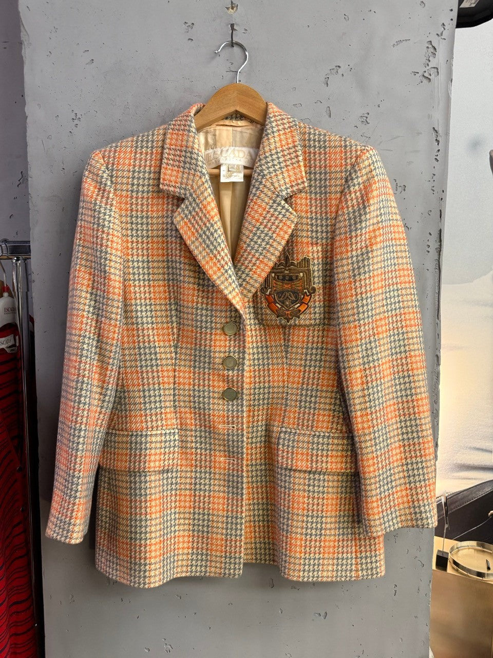 BERLIN VINTAGE CORNER Escada Margaretha Ley vintage plaid blazer in orange and grey wool blend with ornate crest patch.