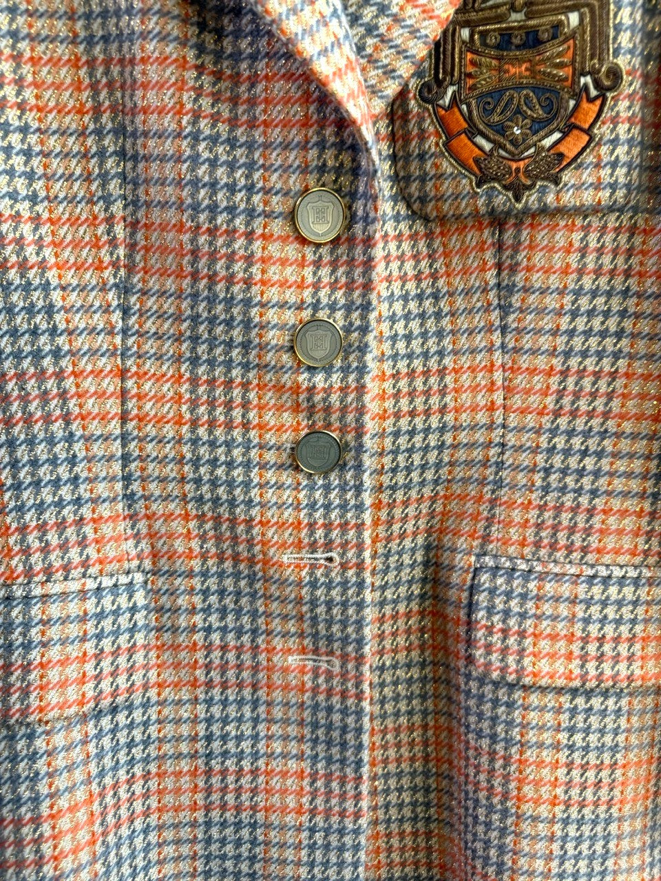 BERLIN VINTAGE CORNER Escada Margaretha Ley vintage orange and grey plaid wool-blend blazer with ornate crest patch.