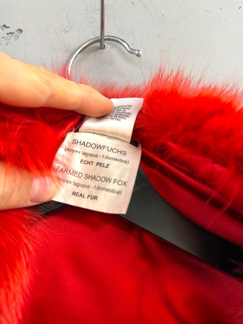 BERLIN VINTAGE CORNER Escada red shadow fox fur collar with care label showing material details on a hanger