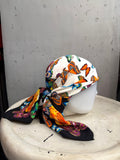 BERLIN VINTAGE CORNER ESCADA silk square scarf with vibrant butterfly and yellow rose print on a mannequin head
