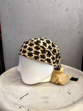 BERLIN VINTAGE CORNER Escada silk square scarf in cream with a black clover print, styled on a mannequin head.