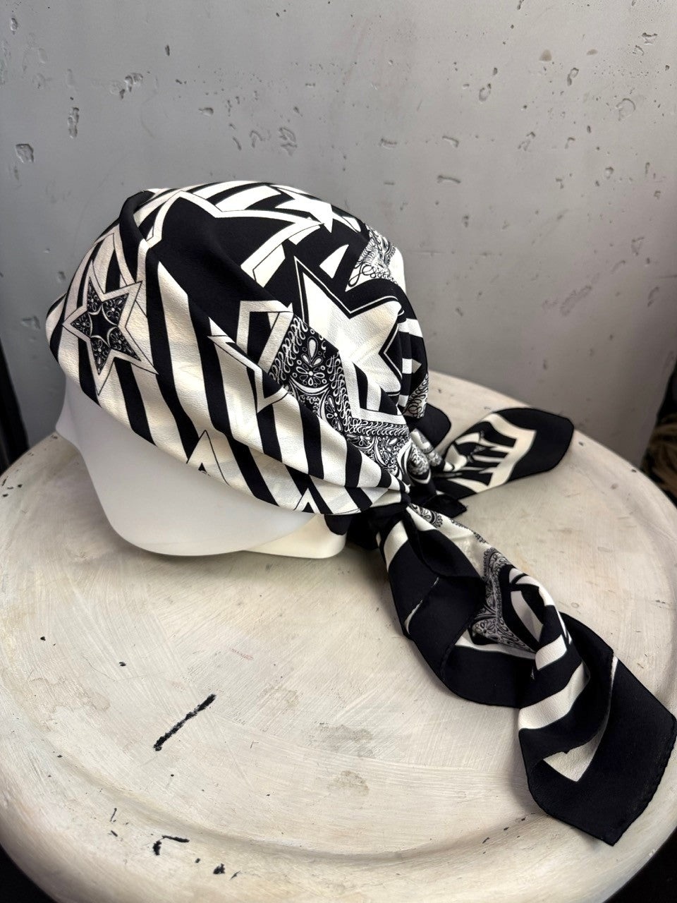 BERLIN VINTAGE CORNER Escada silk scarf in black and white with graphic star and stripe print worn on a mannequin head