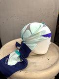 BERLIN VINTAGE CORNER Escada square silk scarf in mint and navy with graphic logo print styled on a mannequin head