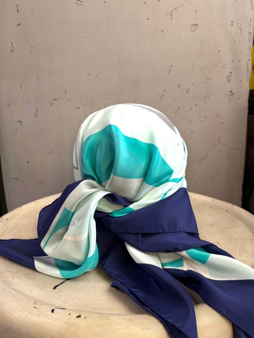 BERLIN VINTAGE CORNER Escada square silk scarf in mint, navy, and neutral graphic print draped on a display stand.