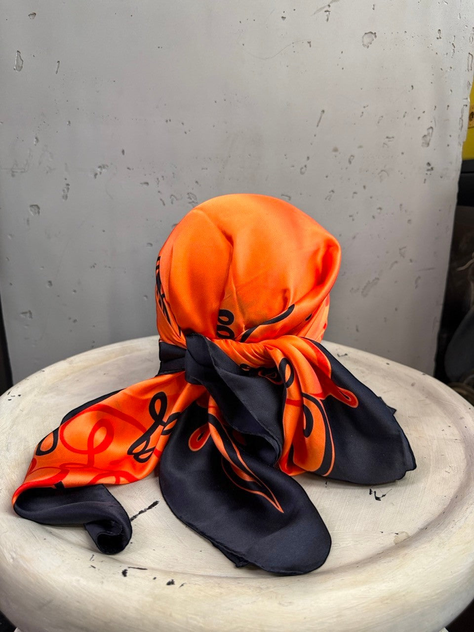 BERLIN VINTAGE CORNER Escada silk scarf in vibrant orange and black with ornate scrollwork tied as a headscarf
