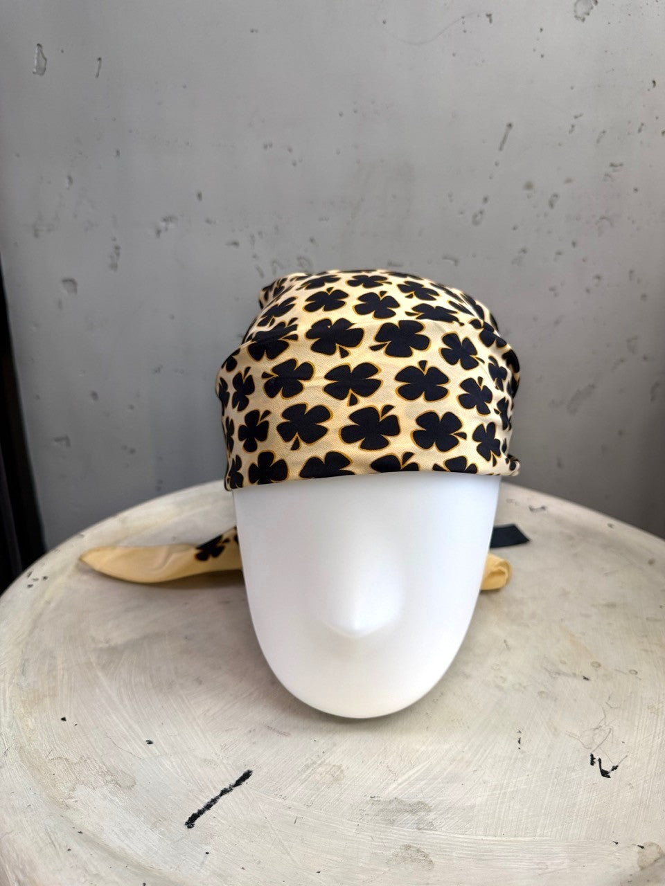 BERLIN VINTAGE CORNER Escada cream silk square scarf with black clover print draped on a mannequin head