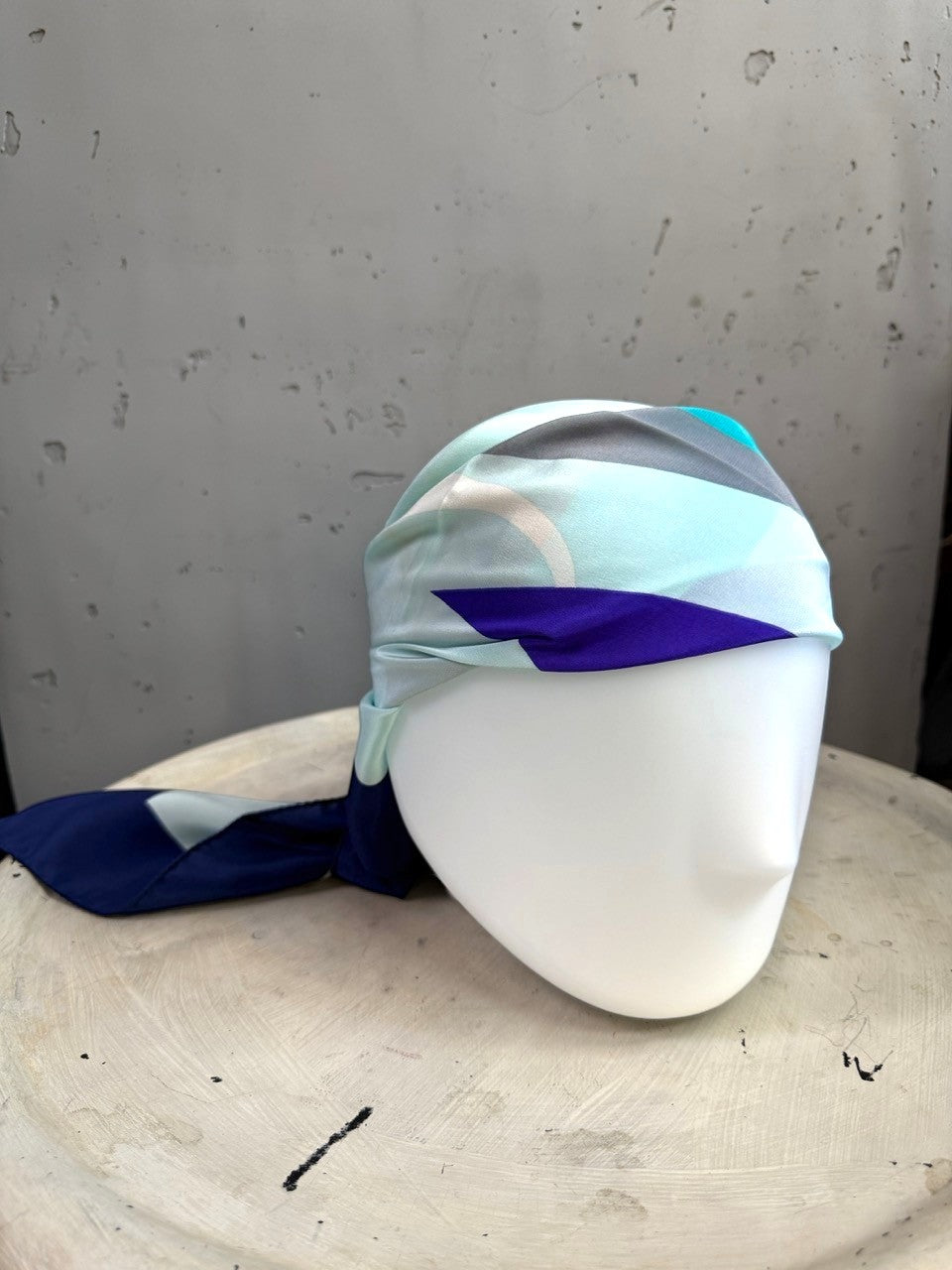 BERLIN VINTAGE CORNER Escada square silk scarf in mint, navy, and neutral graphic print styled on a mannequin head