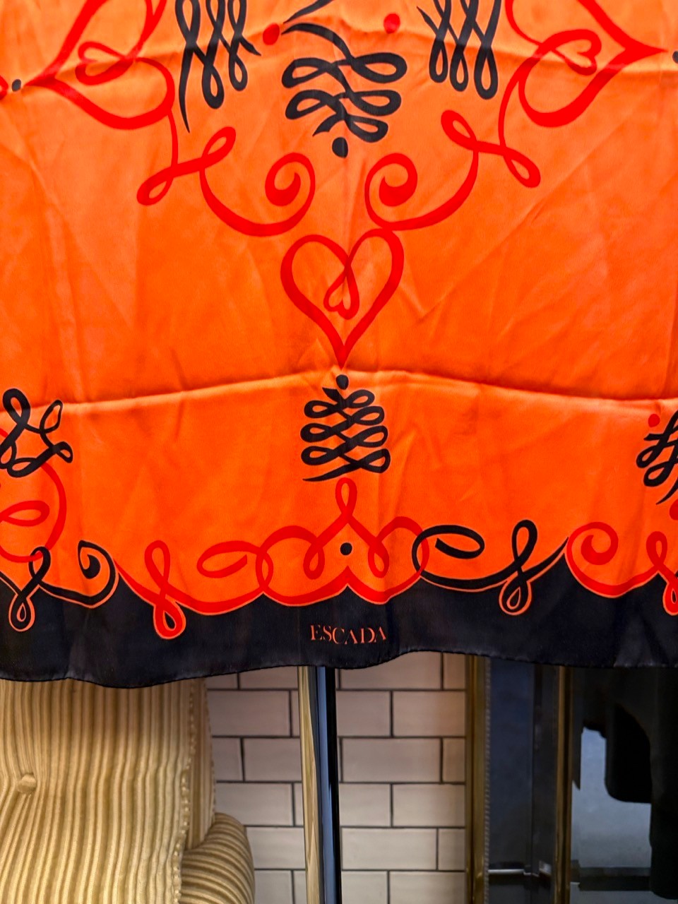 BERLIN VINTAGE CORNER vintage Escada silk scarf in vibrant orange and black with ornate scrollwork and heart patterns.