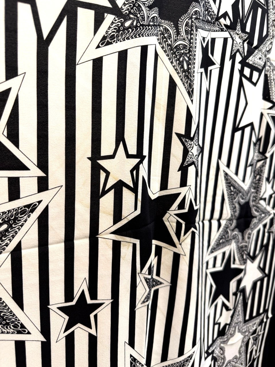 BERLIN VINTAGE CORNER Escada silk scarf featuring black and white vertical stripes with paisley star motifs.